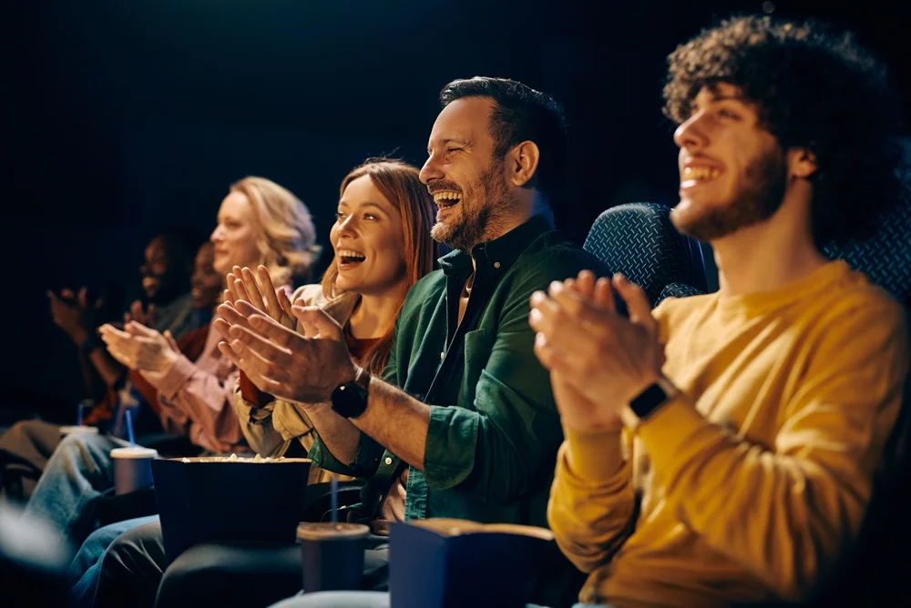 Happy man and his friends applauding