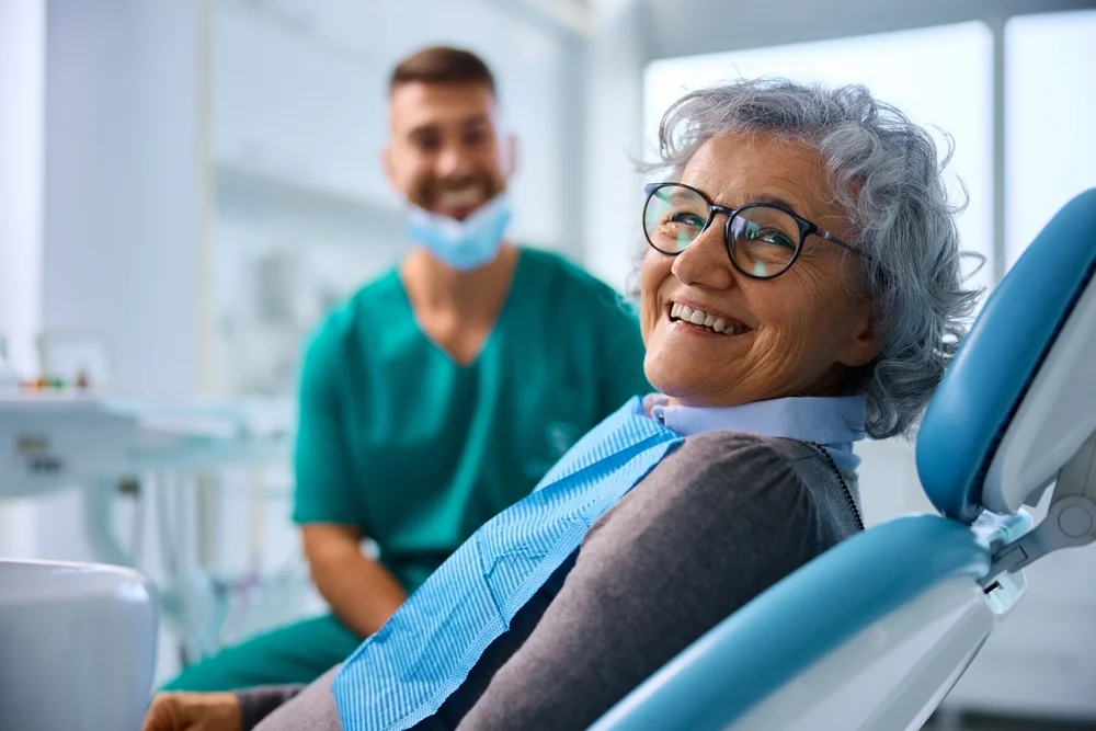 Happy senior woman at Dental Clinic looking at a camera