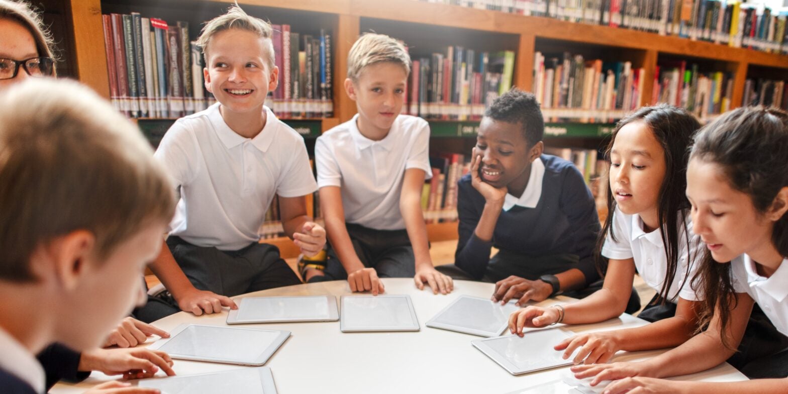 Elementary school kids in library group of students in school
