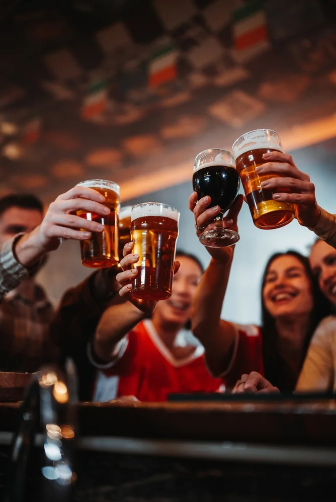 Group of diverse friends toasting with various beer glasses celebrating