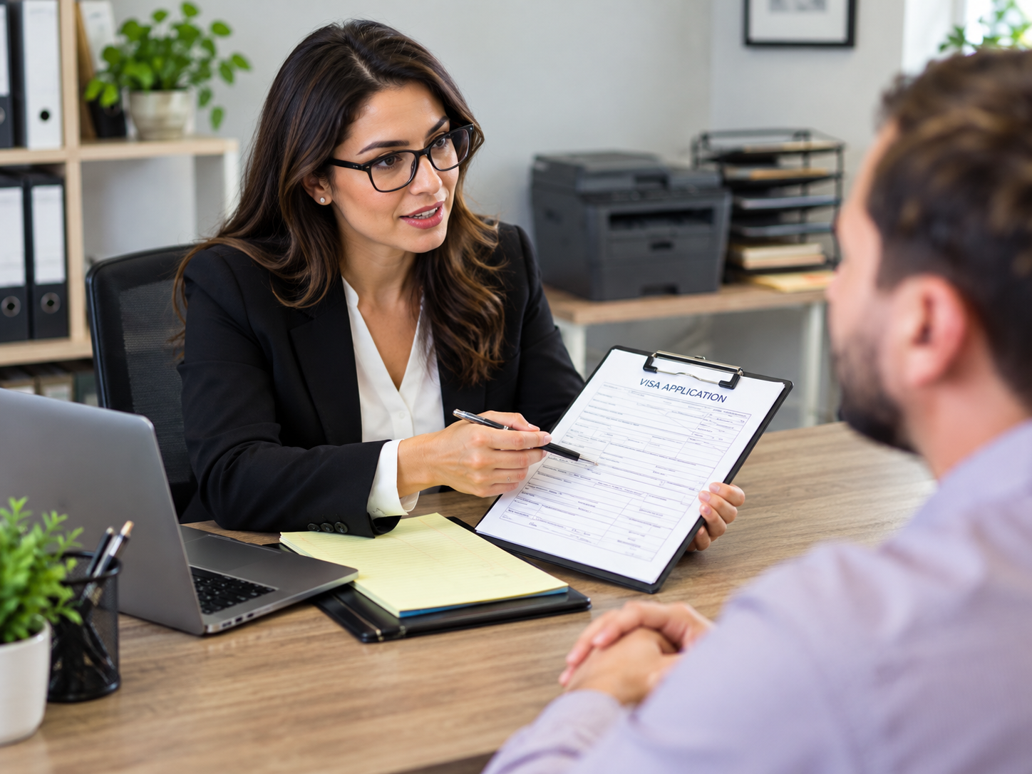 Female immigration lawyer reviewing a visa application form with a male client during a professional office consultation