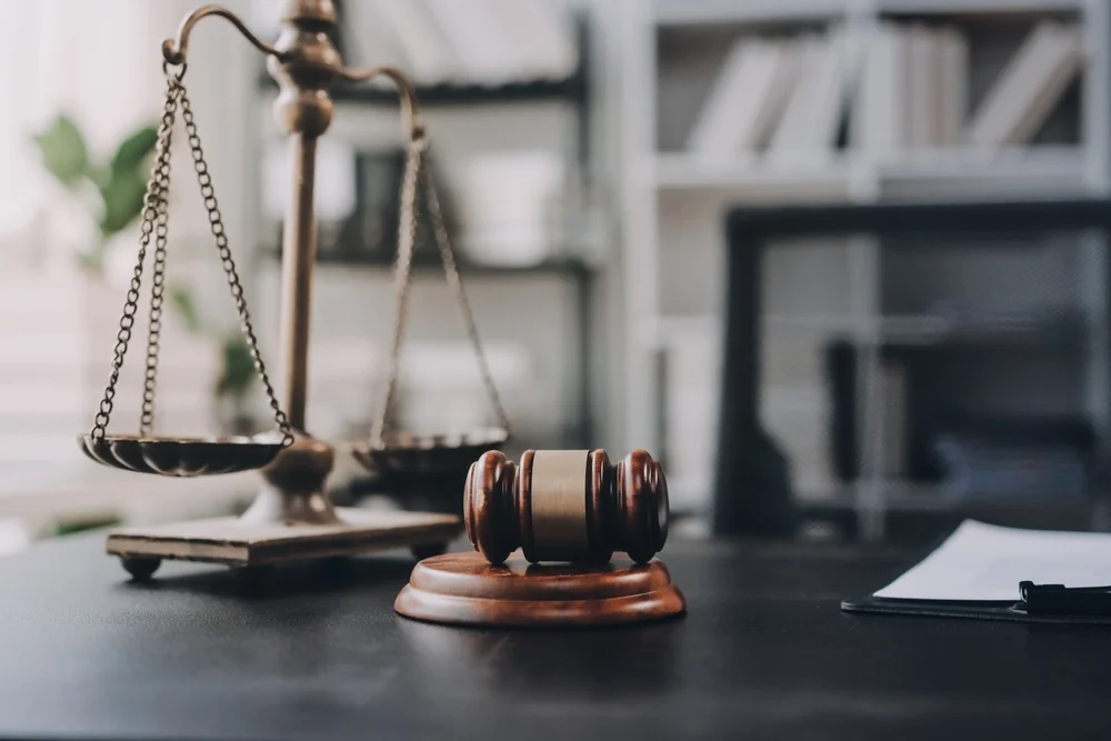 A table of a lawyer with gavel and balance scale