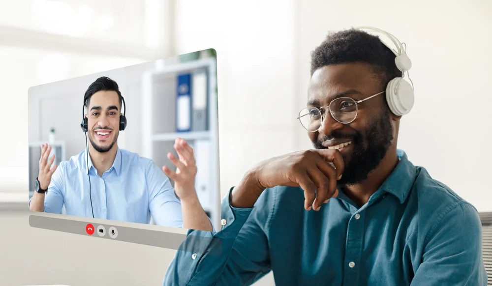 Black young businessman immersed in virtual video meeting for SAAS product
