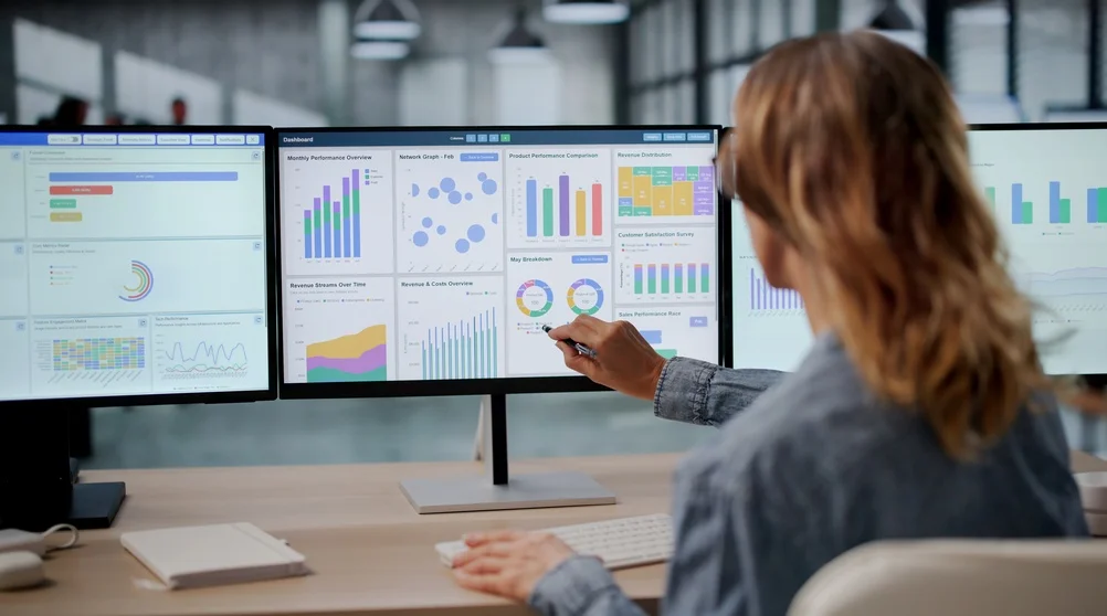 SaaS marketing team reviewing website traffic, campaign performance, and lead generation data on analytics dashboards.