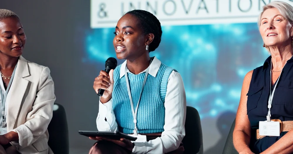 Business women speaker and microphone for seminar presentation and audience